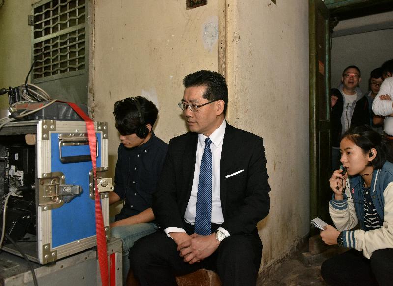 Mr So (centre) listens to the production crew's introduction of the filming process.