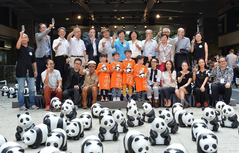 Mrs Lam (centre, back row) proposes a toast with other officiating guests.