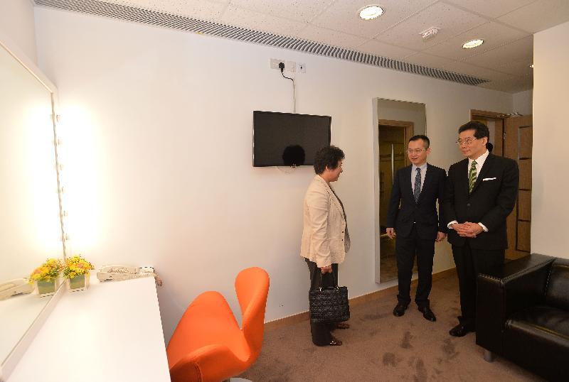 Mr Gregory So (first right) tours the dressing room attached to a screening house.