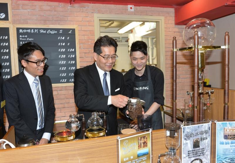 Mr So (centre) tries brewing coffee at Pok Oi Café.