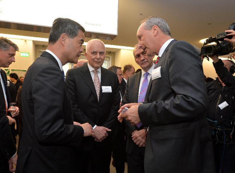 Mr Leung (left) chats with guests at the reception.