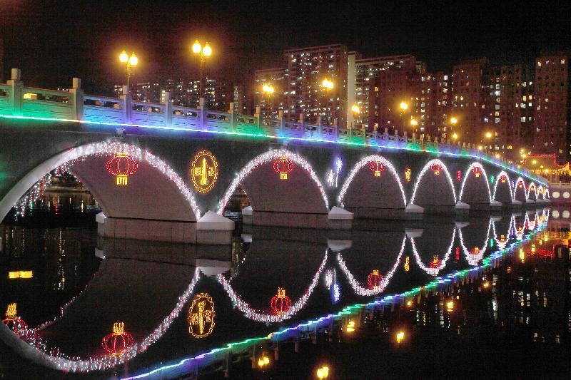 Festive lights illuminate Sha Tin's Lek Yuen Bridge and the Shing Mun River.